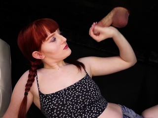 Curvy redhead with bracers does handjob